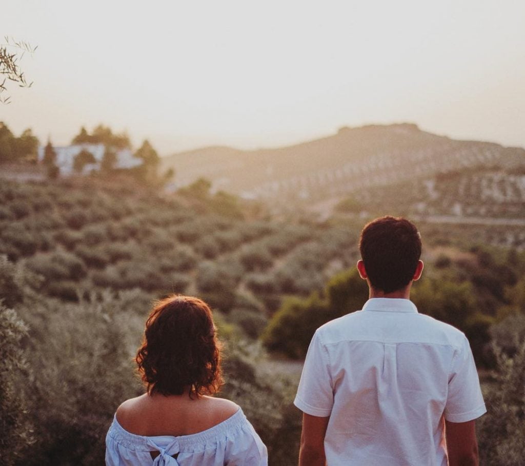 a couple looking into the distance in the andalucian hills