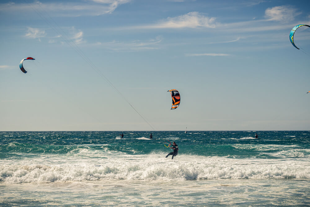 Kitesurfers in Praia do Guincho, one of the best beaches in Portugal