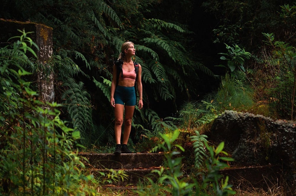 A woman walking through the Laurisilva forest