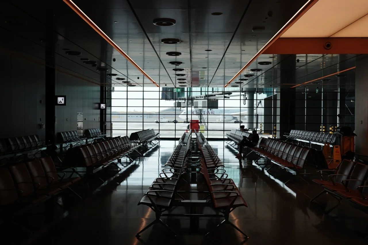Airport departure hall with passengers and luggage